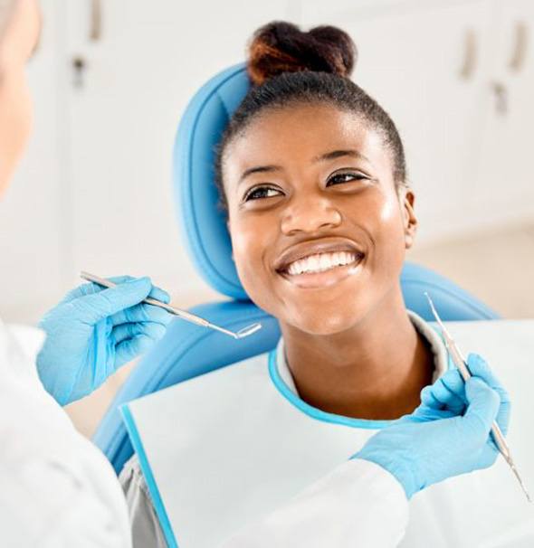 Happy patient smiling up at her dentist