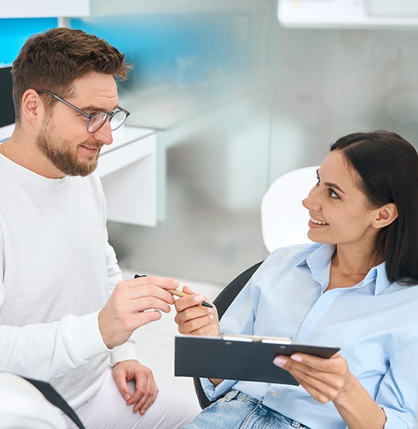 Dental team member helping patient with dental insurance in Braintree