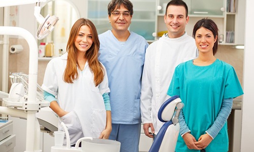 Dental team smiling in a treatment room