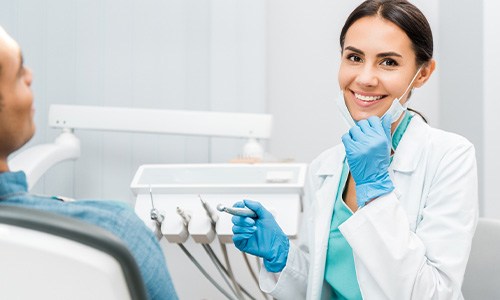 Dentist smiling at patient's dental exam