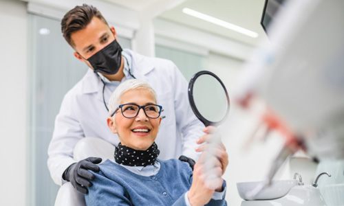 a woman showing off her dental implants 