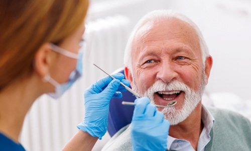 a woman showing off her dental implants 